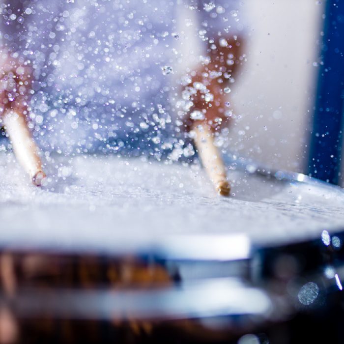indian man playing the drums sticks close-up in recording studio .